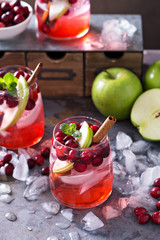 Winter refreshing drink with apples and cranberry