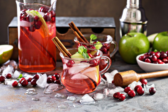 Winter refreshing cocktail with apples and cranberry