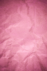 Pink crumpled recycle paper background.