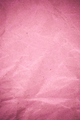 Pink crumpled recycle paper background.