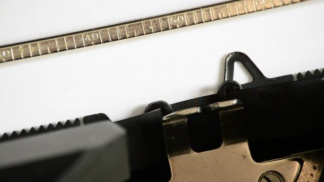 Typing the word QUESTIONS with an old manual typewriter