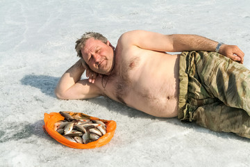 Man with fish on ice. Big lake, Siberia