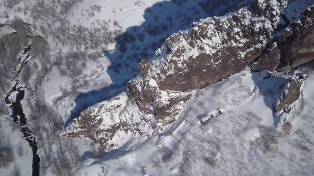 Aerial snowy winter mountain valley and ridge. Winter snow on landscape of central Utah. Cold season weather. Nature and environment. Beautiful natural environment. Drone flight.