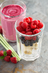 Berry smoothie ingredients in tall glass