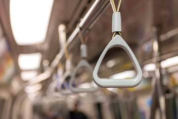 Handles on ceiling for standing passenger inside a bus