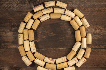Wine corks circle on wooden texture with copyspace