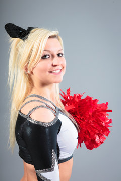 Young Cheerleader On Gray Background