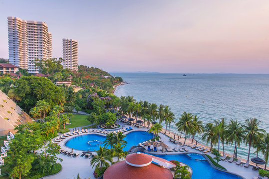 Top view of Swimming pools at tropical beach in luxury hotel