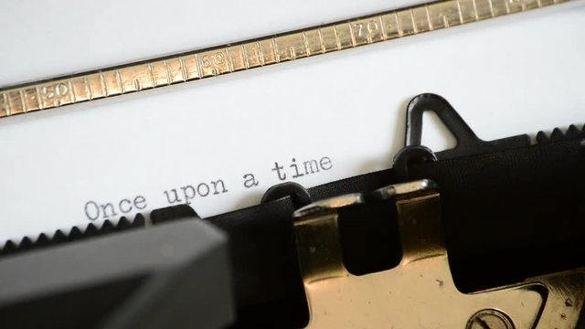 Typing the expression Once upon a time with an old manual typewriter