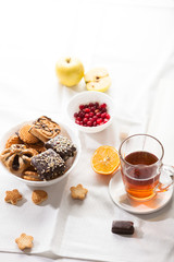 Tea and sweets on white background