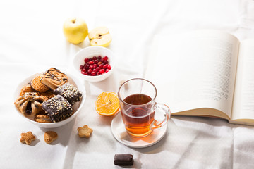 Tea and sweets on white background