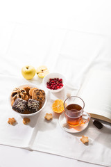 Tea and sweets on white background