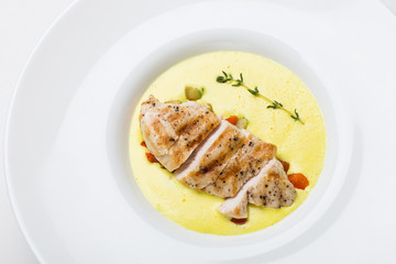 Cream soup with chicken on white background