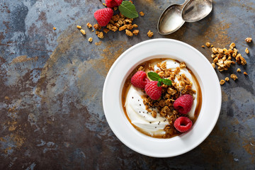Yogurt bowl with raspberry and maple syrup
