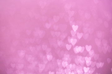 defocused lights bokeh background of pink hearts