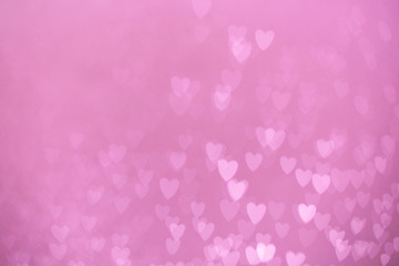 defocused lights bokeh background of pink hearts