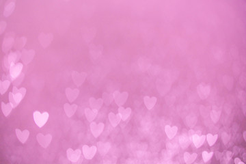 defocused lights bokeh background of pink hearts