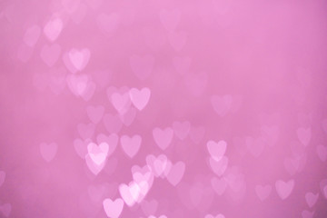 defocused lights bokeh background of pink hearts