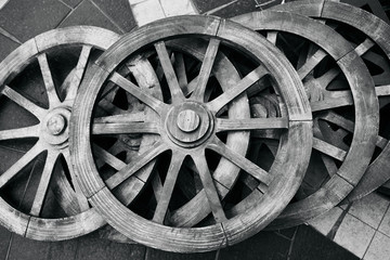 Fototapeta na wymiar Old rustic wooden wagon wheels. Black and white