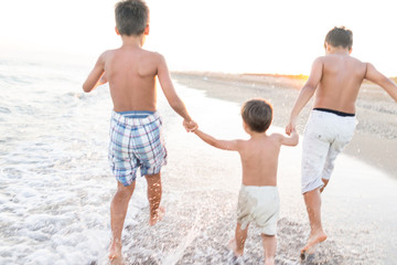 Fun kids playing splash at beach