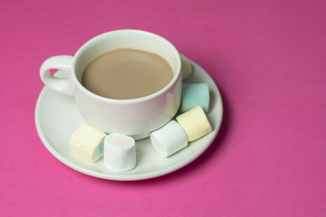 hot chocolate with marshmallows in a ceramic cup on pink paper b