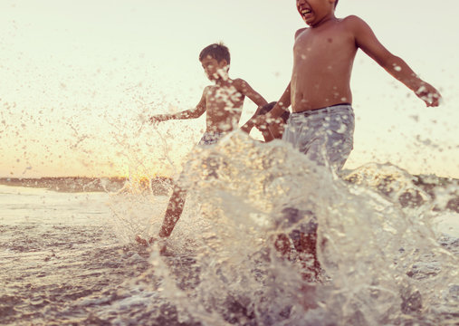 Fun Kids Playing Splash At Beach