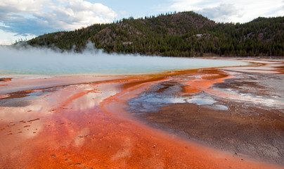 Grand Prismatic Hot Spring under sunset clouds in the Midway Geyser Basin in Yellowstone National Park in Wyoming USA