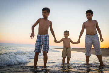 Fun kids playing splash at beach