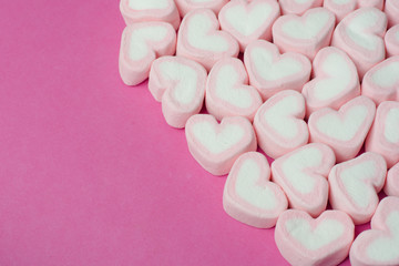 Pink heart shaped marshmallows background