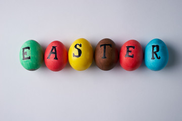 Top view of colorful easter eggs on white background