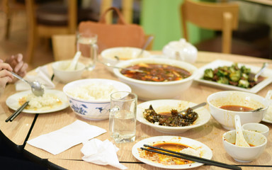 People eating Szechuan Chinese food
