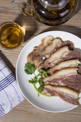 Delicious Chinese food, pig`s cheek meat,  pieces of meat cut from a pig`s head served as a cold dish to go with drinks, some marinated food in China.
