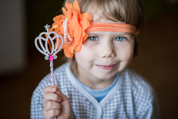 Little girl holding a magic wand. Game wizards