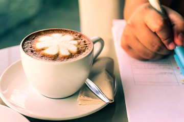 Closeup cups of hot coffee in Coffee Shop Cafe Restaurant. business female working , Concept working anyway anytimes or freelance