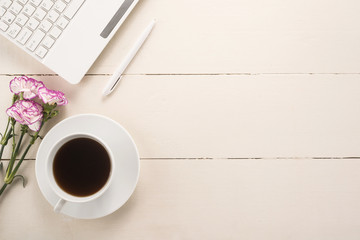 Obraz na płótnie Canvas Office table with cup of coffee and flowers