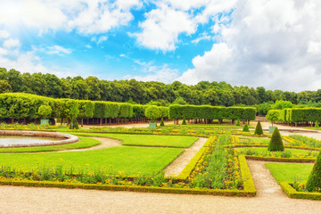 Fototapeta na wymiar Grand Trianon gardens is famous French-style gardens “filled w