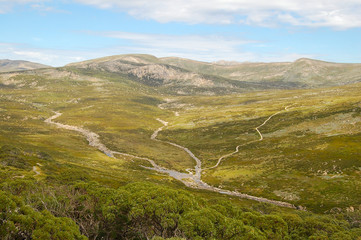 Fototapeta na wymiar A walking track crosses the creeks below the Charlotte Pass of the Snowy Mountains in New South Wales, Australia