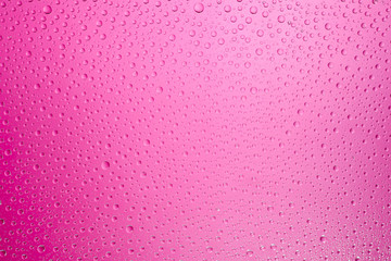 Water drops pink background. Water drops on glass background