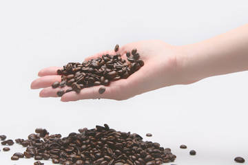 Woman taking coffe beans with her hand