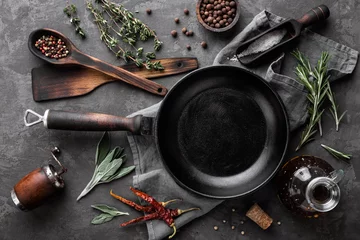Fotobehang dark culinary background with empty black pan and space for text recipe or menu © Sunny Forest