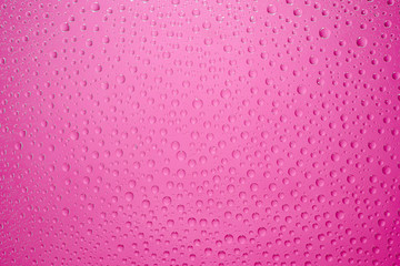 Water drops pink background. Water drops on glass background