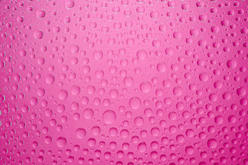 Water drops pink background. Water drops on glass background