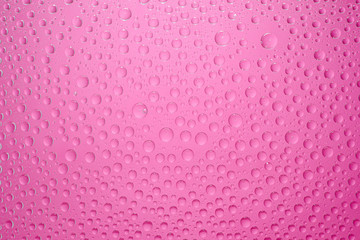 Water drops pink background. Water drops on glass background