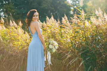 Beautiful young bridesmaid with curly hair