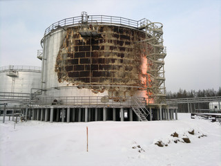 Firemen extinguish a oil reservoir;