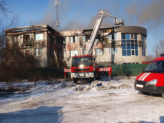 Firemen extinguish a house and building;