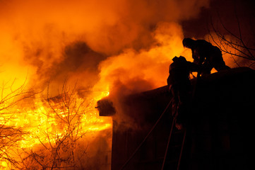 Firefighters extinguish a house