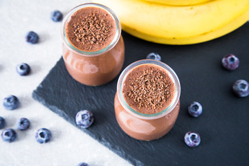 Obraz na płótnie Canvas Chocolate banana smoothie with chia seeds and blueberry 