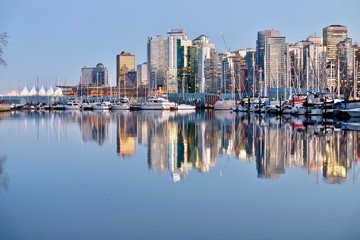 Vancouver Skyline and reflection in calm water. Coal Harbor. View from Stanley Park. West End. Downtown Vancouver. British Columbia. Canada.