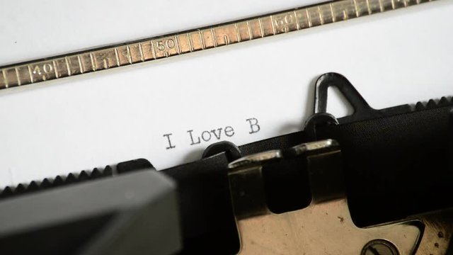 Typing the expression I Love Blogging with an old manual typewriter
